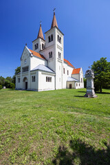 Church of Saint Stephen standing tall in Bina, Slovakia, under blue sky