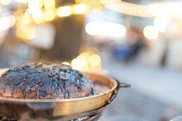A pot of burnt and dirty and food stains on pot stove for pork grilled after eating finish on light...