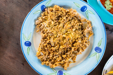 Deep fried crab omelette Thai style, crispy, thick and oily, unhealthy cholesterol but delicious, seafood meal in Thai local restaurant