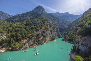Tourists enjoying turquoise water of Verdon Gorge in pedal boats and kayaks