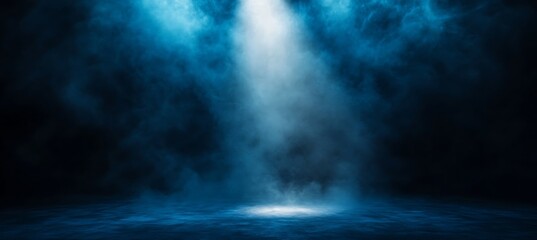 Dramatic bright blue spotlight illuminates a smoky atmospheric stage with a textured floor creating a powerful sense of focus and anticipation