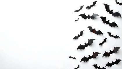 Obraz premium Black bat silhouettes artfully arranged against a plain white background, creating a minimalist Halloween aesthetic.