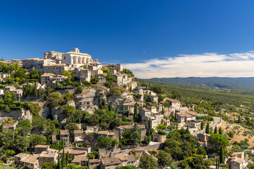 Obraz premium Gordes dominating the landscape in Provence, France, under a blue sky