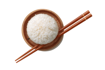 A round, wooden bowl holds a mound of white rice, with chopsticks crossing over it