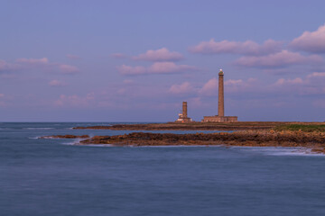 Fototapeta premium Gatteville Lighthouse standing tall at sunset in Normandy, France
