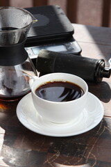 Pour-over filter dripper brewing coffee into glass Alternative coffee brewing method, pure over,...