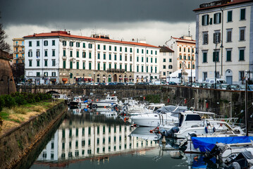 A canal so called "fossi with moored boats in the Venezia Nuova, Livorno, Italy