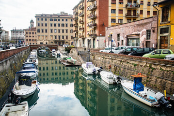 A canal so called "fossi with moored boats in the Venezia Nuova, Livorno, Italy