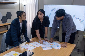 Team members collaborating on business analysis in a modern office space during a meeting