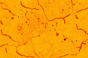 Old orange concrete wall with small cracks.
