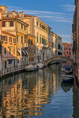 Narrow Venetian canals with colorful historic buildings and gondolas
