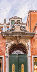 Stone coat of arms with lions on Venetian building facade