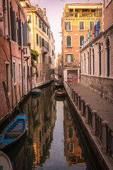 Narrow Venetian canals with colorful historic buildings and gondolas