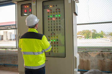 Electrical engineer man checking voltage at the Power Distribution Cabinet,preventive maintenance...