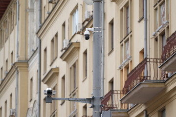 Surveillance cameras mounted on a pole in the city, security system for monitoring urban streets and traffic
