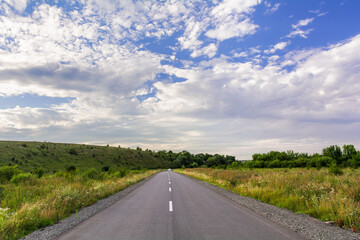 Summer Journey: A Highway in the Countryside Under a Cloudy Sky