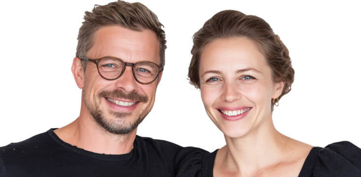 Smiling couple in casual wear exuding joy and warmth against a white background
