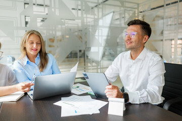 Business team collaborates efficiently in a modern office environment while discussing project...