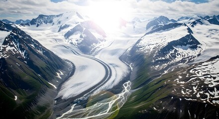 Aerial tracking shot of snowy mountain peaks under clear sky