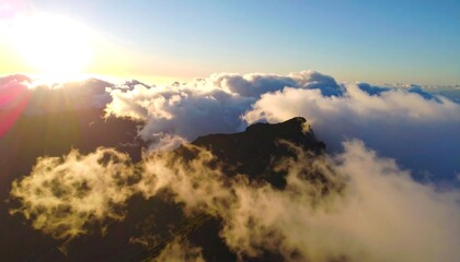 Sunrise over a mountain range veiled in clouds