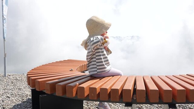 A three-year-old child girl travels in the mountains in the summer, pictured alone, Rosa Khutor, Sochi