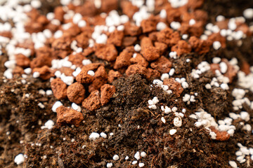 rich organic potting soil with perlite and clay pebbles, perfect for gardening, plant growth, agriculture, horticulture, composting, and sustainable eco friendly farming projects. texture of nutrient.