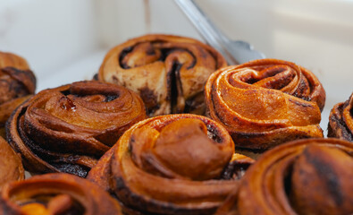 Sweet cinnamon rolls on a table in a local Portuguese bakery. The healthy eating and traditional...