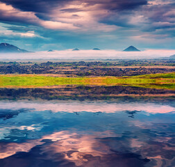 Typical Icelandic landscape with foggy mountains on the horizon