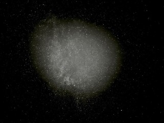 glowing cosmic dust cloud in deep starry night sky with ethereal misty texture for fantasy background or science illustration