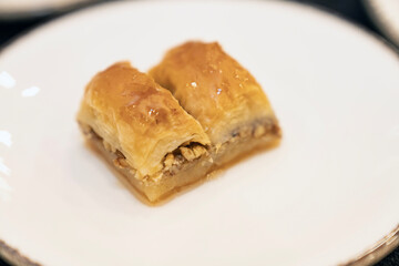 Traditional Turkish Baklava Dessert with Honey and Nuts on White Plate . Authentic Middle Eastern...
