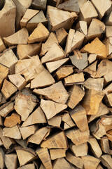 Fototapeta premium Lot of chopped firewood close-up, wood texture. Preparing firewood for the winter. Firewood for the fireplace. Wall of firewood.