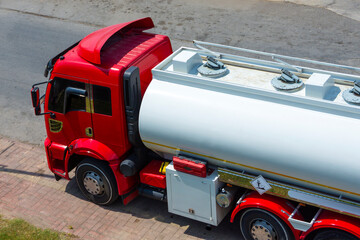 Truck with a tank of flammable liquid fuel wait at a storage facility waiting for dispatcher to...