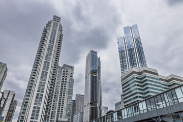 Glass high rise towers in business district with skybridge, contemporary city skyline