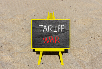 Trade tariff war symbol. Concept word Tariff war on beautiful black blackboard. Beautiful sand...