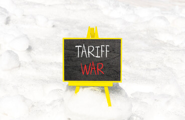 Trade tariff war symbol. Concept word Tariff war on beautiful black blackboard. Beautiful white...
