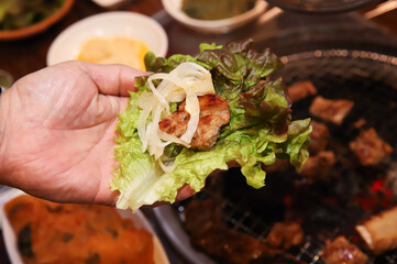 Korean bbq. ssam : eat pork wrapped in lettuce leaves