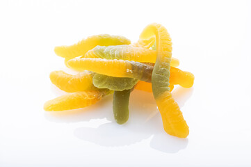 Macro photo of colorful gummy candies shaped like worms.