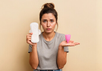Confused Young Woman Comparing Menstrual Pad and Menstrual Cup Feminine Hygiene Choice