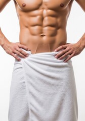 Torso of muscular man with towel around waist hands on hips