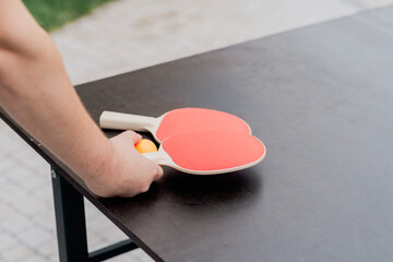 Two paddles and a ball ready for an exciting game of table tennis