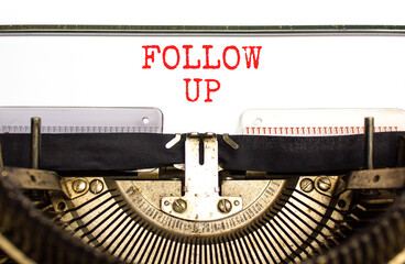 Follow up symbol. Concept word Follow up typed on beautiful old retro typewriter. Beautiful white...
