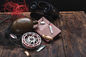 Set of vintage fishing gear with an old Soviet reel and predator fishing lures.
