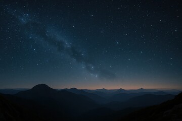 Fototapeta premium A tranquil night sky blanketed with stars over a mountainous landscape, where the Milky Way meets the earthly horizon