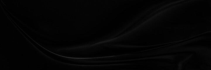 Black gray satin dark fabric texture luxurious shiny that is abstract silk cloth background with patterns soft waves blur beautiful.
