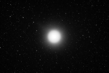 A lone star shines brightly against the vast expanse of space, a solitary beacon in the cosmic sea