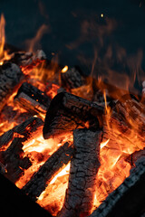 Flame wood in bonfire. Camp barbecue wood charcoal burns in the grill. Blaze fire flame texture...