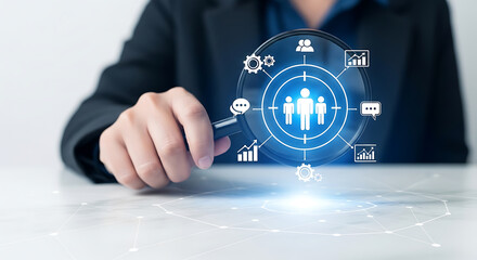 Magnifying glass focusing on people icons, symbolizing targeted marketing and recruitment analysis