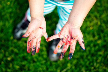 Close-up of a childs paint covered hands after outdoor creative play. Georgia. 2015