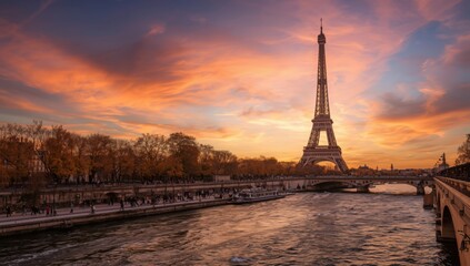 Eiffel tower view from seine river at sunset with orange and pink sky and trees in the background