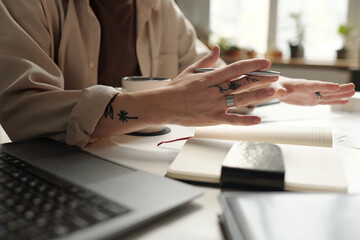 Unrecognizable male hands holding pen while discussing business strategy